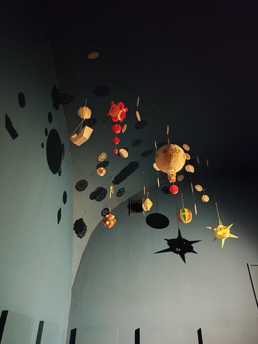 Inside the Ethnographic Museum in Kraków: traditional straw chandeliers (pająki) hang from the ceiling.